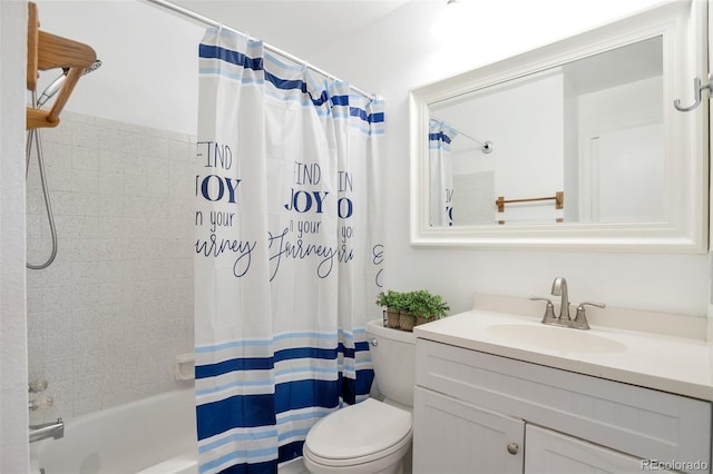 full bathroom with vanity, shower / bath combo with shower curtain, and toilet