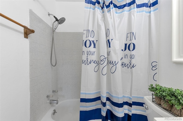 bathroom featuring shower / bath combination with curtain and toilet