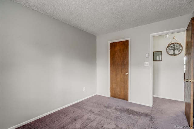 unfurnished bedroom with a textured ceiling and carpet flooring