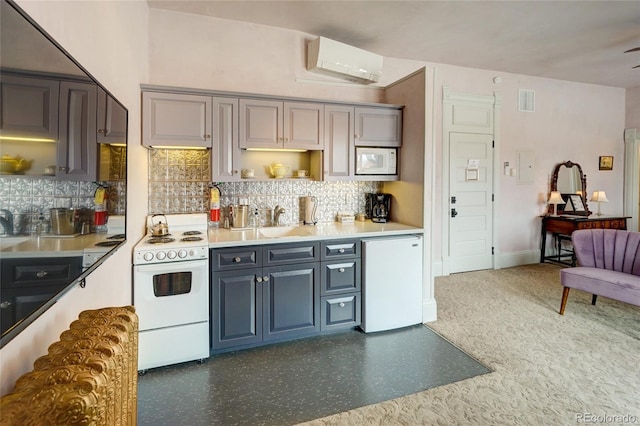 204 N F St Unit D3, Salida, CO 81201 - kitchen with white appliances, a wall unit AC, tasteful backsplash, and gray cabinetry
