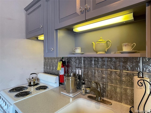 204 N F St Unit D3, Salida, CO 81201 - kitchen with range, gray cabinetry, tasteful backsplash, and light countertops