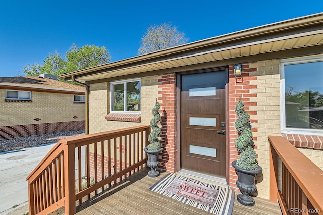 3871 Moore St, Wheat Ridge, CO 80033 - view of exterior entry featuring brick siding and a porch