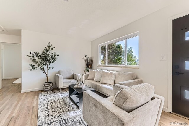 3871 Moore St, Wheat Ridge, CO 80033 - living room with light wood-style flooring and baseboards
