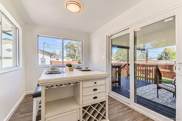 3871 Moore St, Wheat Ridge, CO 80033 - office space with light wood finished floors, healthy amount of natural light, baseboards, and a textured ceiling