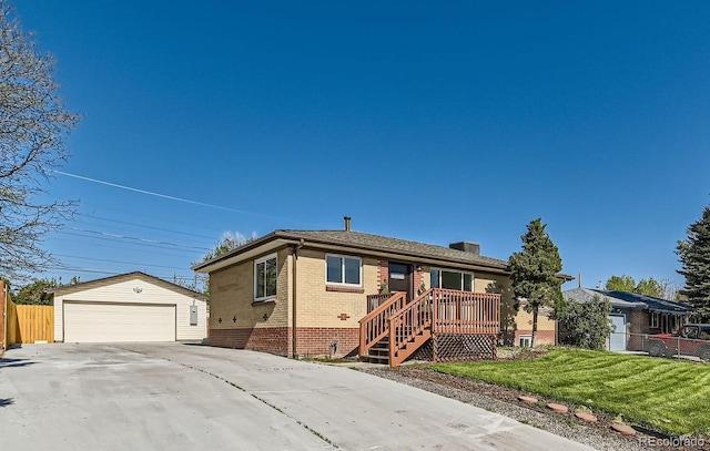 3871 Moore St, Wheat Ridge, CO 80033 - view of front of house with an outdoor structure, brick siding, and a garage