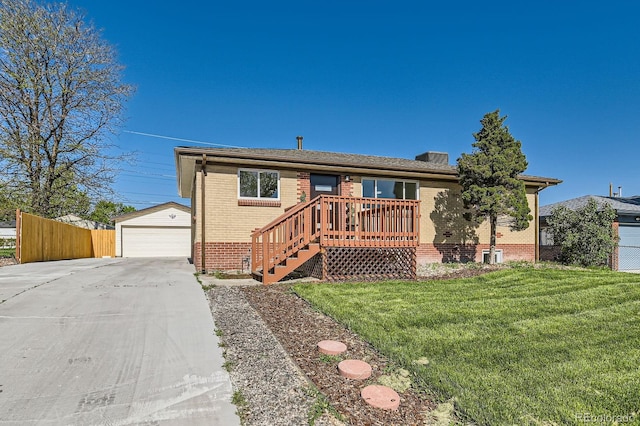 3871 Moore St, Wheat Ridge, CO 80033 - view of front of home featuring brick siding, an outbuilding, and a garage