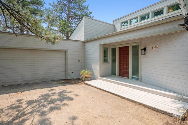 doorway to property with a garage