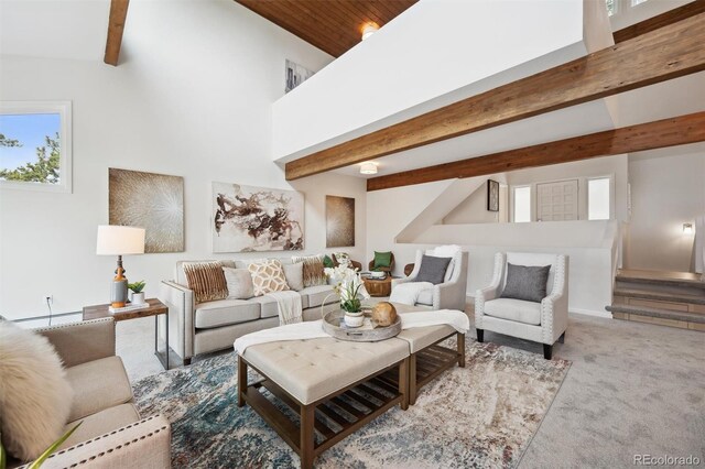 carpeted living room with beam ceiling, a healthy amount of sunlight, and high vaulted ceiling