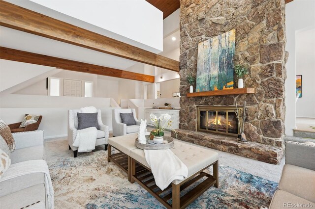 carpeted living room featuring a fireplace, beamed ceiling, and a towering ceiling