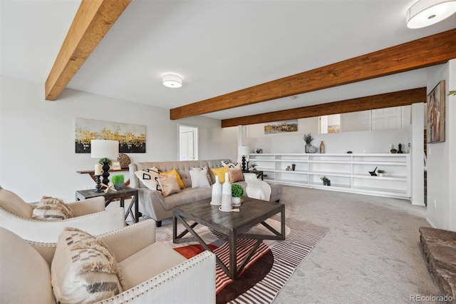 living room with beamed ceiling and carpet flooring