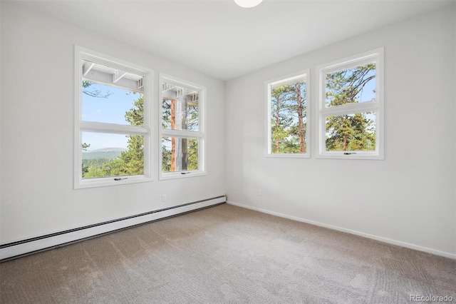 spare room with a baseboard heating unit and carpet floors