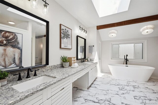 bathroom with tile patterned flooring, a bathtub, a skylight, and double sink vanity