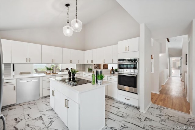 kitchen featuring white cabinetry, a center island, dishwasher, light hardwood / wood-style floors, and double oven