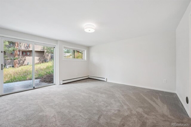 carpeted empty room with a baseboard radiator