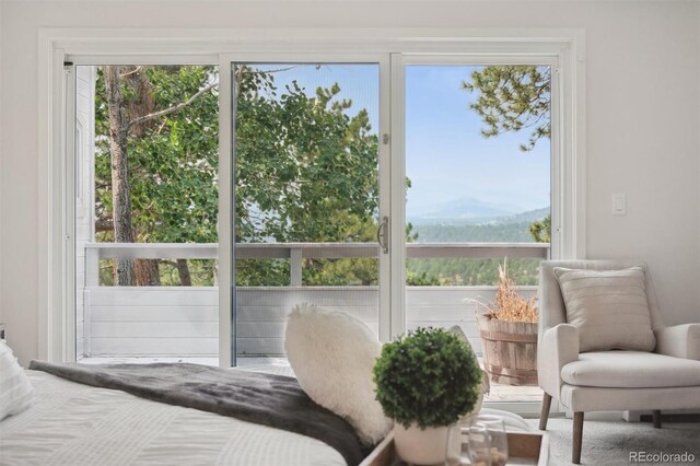 carpeted bedroom with a mountain view and multiple windows