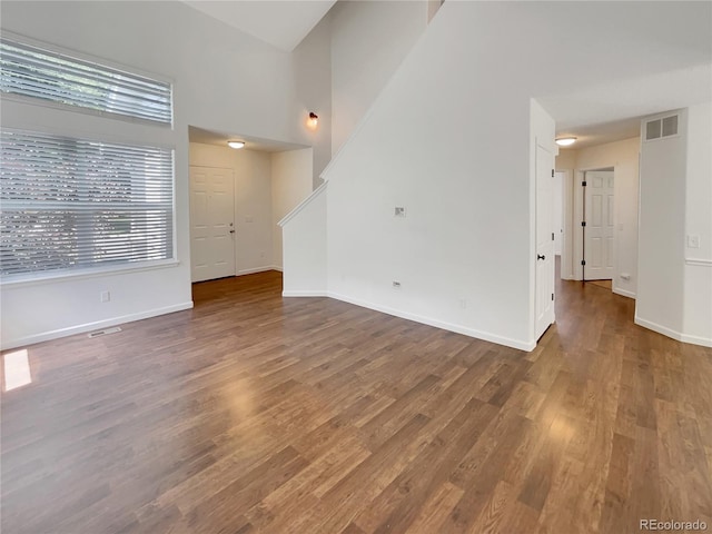 5966 S Winnipeg St, Aurora, CO 80015 - unfurnished living room featuring wood finished floors and a towering ceiling