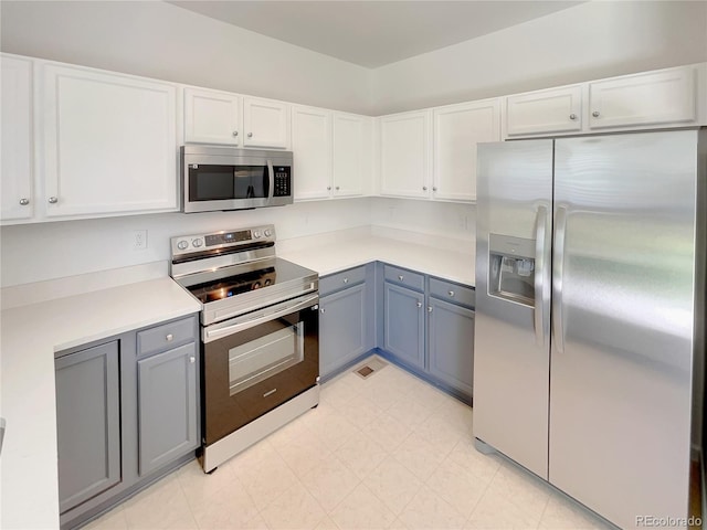 5966 S Winnipeg St, Aurora, CO 80015 - kitchen with appliances with stainless steel finishes, light countertops, white cabinetry, and gray cabinetry
