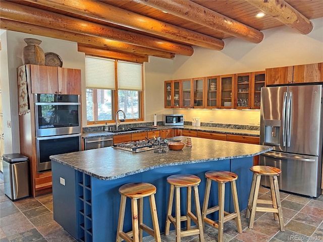 kitchen featuring dark tile floors, stainless steel appliances, beam ceiling, wood ceiling, and sink