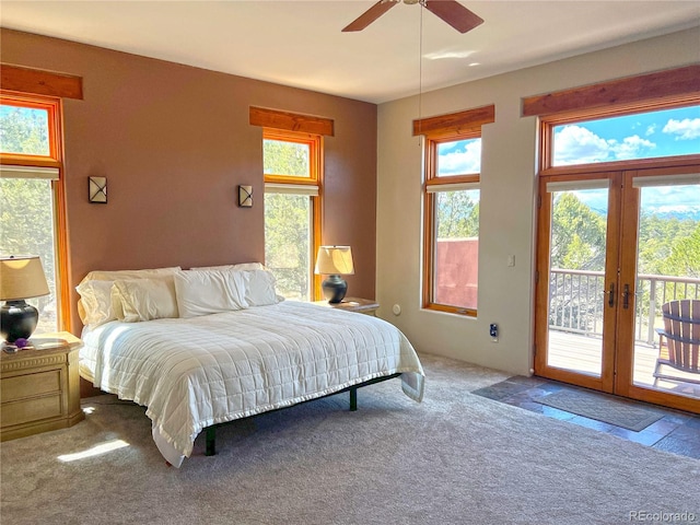 carpeted bedroom featuring ceiling fan, french doors, and access to outside