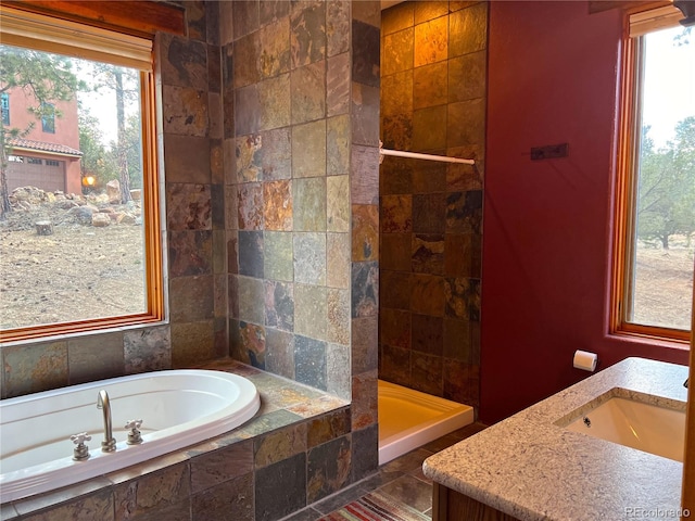 bathroom with tile flooring, vanity, and independent shower and bath