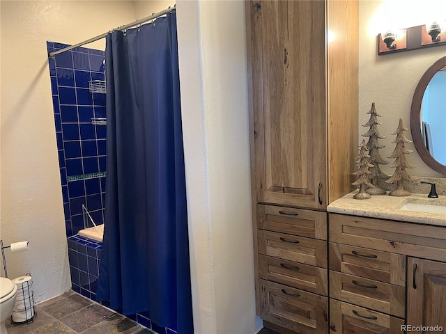 bathroom featuring tile flooring, toilet, and vanity with extensive cabinet space