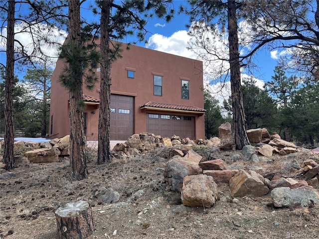 view of property exterior with a garage