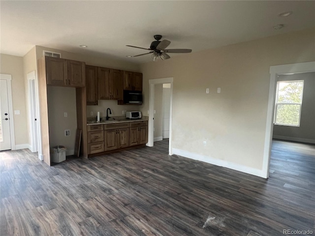 kitchen featuring sink, ceiling fan, and dark hardwood / wood-style flooring