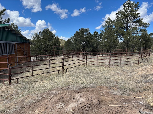 view of yard featuring an outdoor structure and a rural view