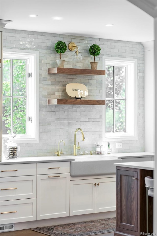 bar with a sink, backsplash, and visible vents
