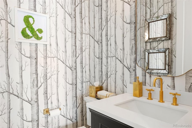 bathroom with vanity and wallpapered walls
