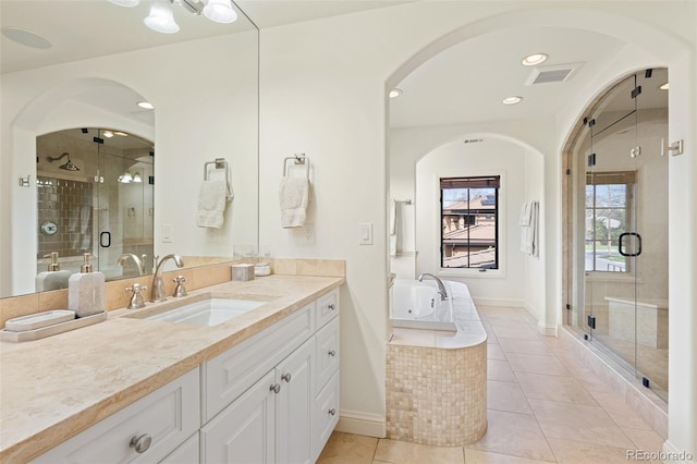 bathroom with a garden tub, a stall shower, visible vents, tile patterned flooring, and vanity
