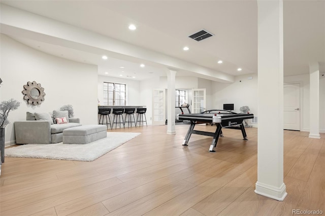 recreation room with light wood-style flooring, recessed lighting, visible vents, and decorative columns