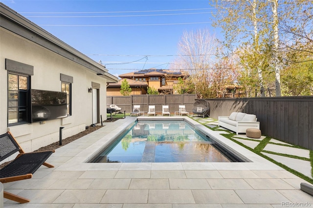 view of pool with a patio, a fenced in pool, and a fenced backyard