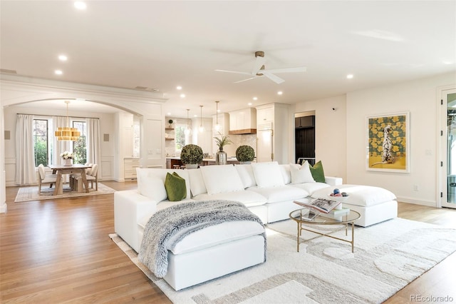 5455 E Cedar Ave, Denver, CO 80246 - living room featuring arched walkways, light wood-style floors, ceiling fan, recessed lighting, and a chandelier