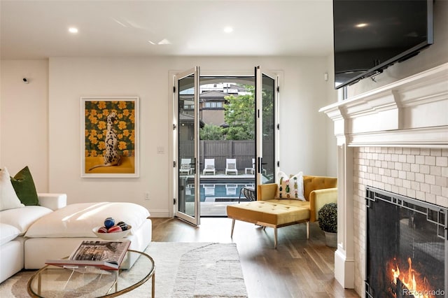 5455 E Cedar Ave, Denver, CO 80246 - living area featuring a tiled fireplace, light wood-style floors, and recessed lighting