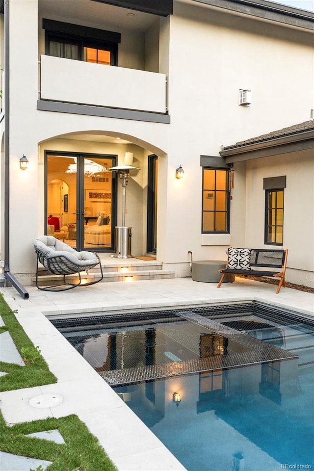 5455 E Cedar Ave, Denver, CO 80246 - back of property with stucco siding, an outdoor pool, and a balcony