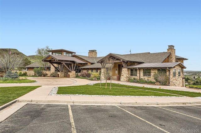 15325 W 32nd Ave, Golden, CO 80401 - view of front of home with a chimney, a front yard, stone siding, and uncovered parking