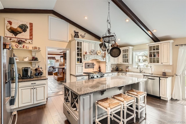 15325 W 32nd Ave, Golden, CO 80401 - kitchen with a kitchen island, a wealth of natural light, stainless steel appliances, and lofted ceiling with beams
