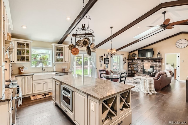 15325 W 32nd Ave, Golden, CO 80401 - kitchen featuring a sink, stainless steel appliances, a healthy amount of sunlight, and vaulted ceiling with beams
