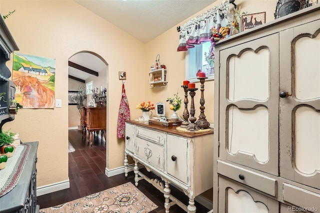 15325 W 32nd Ave, Golden, CO 80401 - corridor featuring vaulted ceiling, baseboards, dark wood-type flooring, and arched walkways