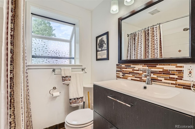 15325 W 32nd Ave, Golden, CO 80401 - bathroom with toilet, visible vents, tasteful backsplash, and vanity