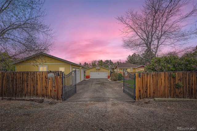 15325 W 32nd Ave, Golden, CO 80401 - exterior space featuring a gate, a detached garage, a fenced front yard, and driveway