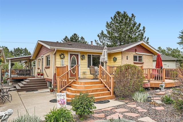 15325 W 32nd Ave, Golden, CO 80401 - view of front of property featuring a patio area, roof with shingles, and a deck