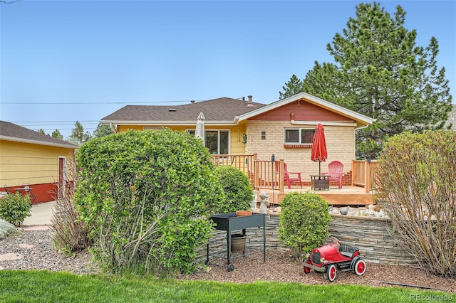 15325 W 32nd Ave, Golden, CO 80401 - view of front of home with a wooden deck and brick siding