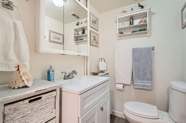 15325 W 32nd Ave, Golden, CO 80401 - bathroom with toilet, vanity, and wood finished floors