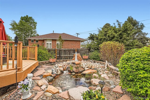 15325 W 32nd Ave, Golden, CO 80401 - view of yard with a small pond, fence, and a wooden deck