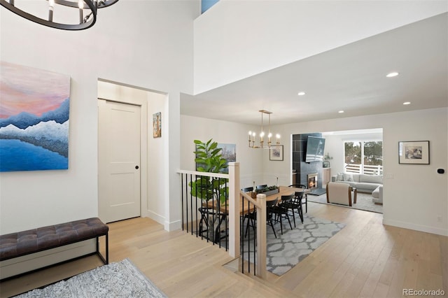 dining area with an inviting chandelier and light hardwood / wood-style flooring