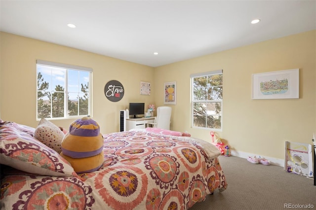 carpeted bedroom featuring multiple windows