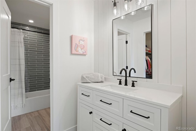 bathroom featuring vanity, wood-type flooring, and shower / tub combo with curtain