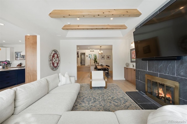 7079 S Locust Pl, Centennial, CO 80112 - living area featuring a tiled fireplace, light wood-type flooring, and recessed lighting